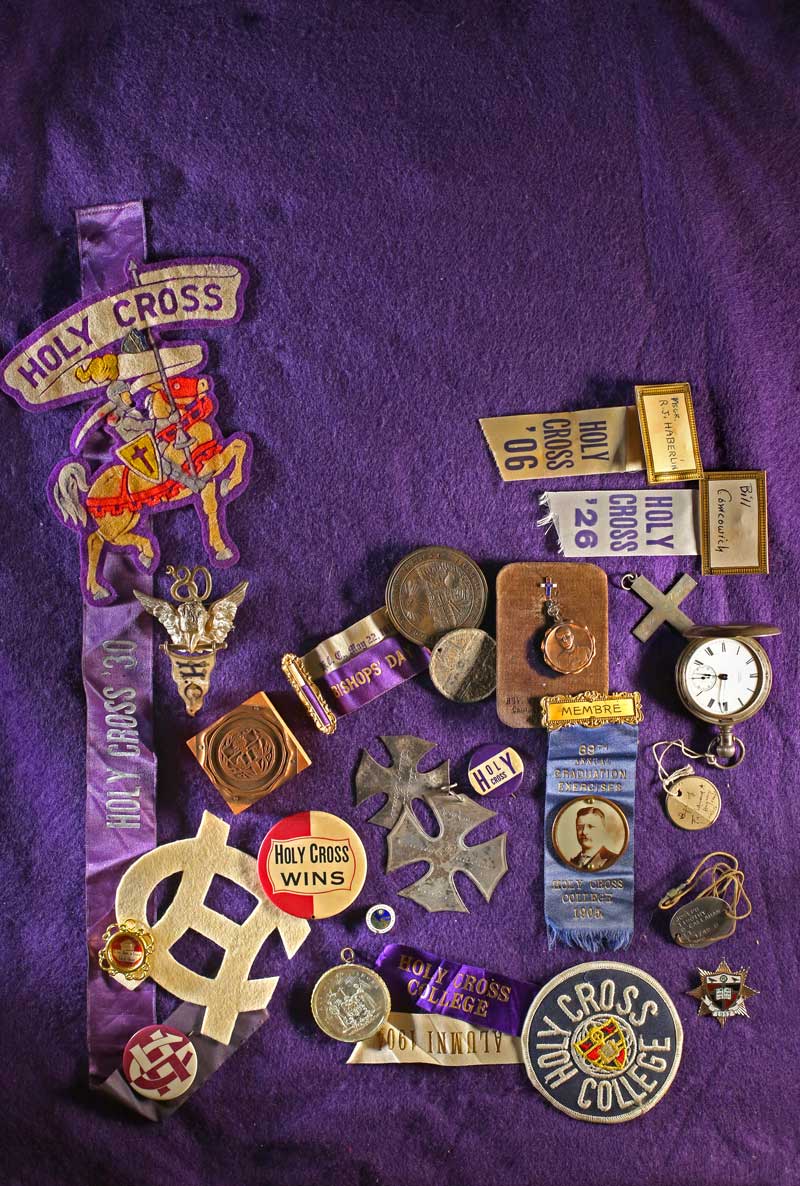 Archival display of Holy Cross patches, medals, and ribbons.